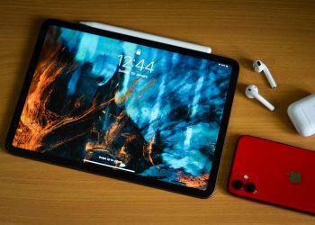 a tablet with a picture on it next to a red phone
